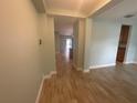 Inviting hallway featuring tile flooring and neutral paint, leading to other rooms at 878 Benjamin Trl, Davenport, FL 33837