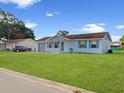 View of the home's exterior with a well-manicured lawn at 98 Pinata Ct, Kissimmee, FL 34743