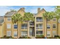 Condo exterior features multiple balconies, palm trees, and convenient stair access at 1065 S Hiawassee Rd # 1425, Orlando, FL 32835