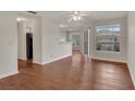 Bright living room features wood floors, large windows, and a contemporary ceiling fan at 1065 S Hiawassee Rd # 1425, Orlando, FL 32835