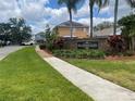 Welcoming Heather Glen neighborhood sign amidst lush landscaping and mature palm trees at 1211 Carey Glen Cir, Orlando, FL 32824