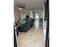 Inviting living room with tile floors, neutral paint, ceiling fan, and an open layout at 1211 Carey Glen Cir, Orlando, FL 32824