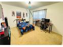 Comfortable bedroom featuring carpet flooring, modern decor, and a spacious layout ideal for a relaxing retreat at 1419 Avenue D Ne, Winter Haven, FL 33881