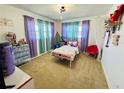 Cozy bedroom featuring colorful curtains, playful decorations, and a comfortable bed, creating an inviting space at 1419 Avenue D Ne, Winter Haven, FL 33881