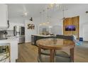 Open-concept kitchen with a center island, dining area, and adjacent living room for seamless entertaining at 147 Bridgewater Dr, Davenport, FL 33897