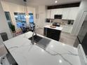 Bright kitchen featuring white cabinets, stainless appliances, an eat-in area with an island, and pendant lighting at 14963 Yorkshire Run Dr, Orlando, FL 32828