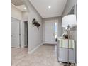 Inviting foyer features tile flooring, neutral paint colors and a light gray console table at 1557 Alligator St, St Cloud, FL 34771