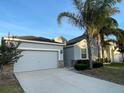 Well-maintained single-story home with a two-car garage, neat landscaping, and attractive curb appeal at 1574 Thetford Cir, Orlando, FL 32824