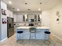 Modern kitchen with marble countertops, stainless steel appliances, and stylish pendant lighting at 1574 Thetford Cir, Orlando, FL 32824