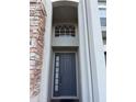 View of front door with stone facade and detailed window at 15851 Woodland Spring Ct, Orlando, FL 32828