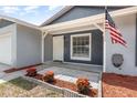 Welcoming front entrance with tidy landscaping, a decorative sidewalk, and a freshly painted front door at 1622 Crystalview Trl, Lakeland, FL 33801