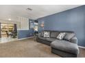 Cozy living room featuring a sectional sofa, carpet flooring, and neutral wall color at 1622 Crystalview Trl, Lakeland, FL 33801