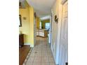 Hallway view shows tile flooring and leads into an open layout with dining area at 1820 Hallcrest Dr, Deltona, FL 32725