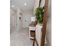 Inviting entryway featuring neutral walls, tile flooring, and decorative accents adding charm to the home's interior at 1821 Cayman Cove St., St Cloud, FL 34772