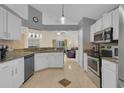 Bright, spacious kitchen with granite countertops, white cabinetry, and stainless steel appliances at 2398 Queenswood Cir, Kissimmee, FL 34743
