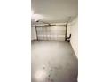 Spacious, two car garage with white walls, automatic door opener, and smooth concrete floors at 242 Abbotsbury Dr, Kissimmee, FL 34758