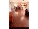 Spacious living room and kitchen area featuring hardwood floors and natural lighting at 242 Abbotsbury Dr, Kissimmee, FL 34758