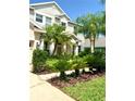 Beautiful front yard with tropical landscaping and a well-maintained lawn at 3341 Pawleys N Loop, St Cloud, FL 34769