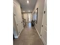 Inviting hallway with tile flooring, stylish decor, and natural light streaming through the front door at 3920 Southern Vista Loop, St Cloud, FL 34772