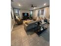 Spacious living room featuring tile floors, modern furniture, and plenty of natural light at 3920 Southern Vista Loop, St Cloud, FL 34772
