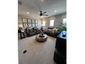 Comfortable living room with plush seating, a ceiling fan, and windows providing natural light at 3920 Southern Vista Loop, St Cloud, FL 34772