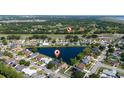 Gorgeous aerial view of a home nestled by a lake in a serene community with green surroundings and water views at 3928 Blackberry Cir, St Cloud, FL 34769