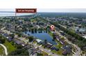 Beautiful aerial view showcasing a lakeside home in a peaceful neighborhood near East Lake Tohopekaliga, surrounded by greenery at 3928 Blackberry Cir, St Cloud, FL 34769