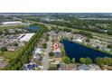 Aerial view of a charming home situated in a quiet neighborhood near a scenic lake and lush green spaces at 3928 Blackberry Cir, St Cloud, FL 34769