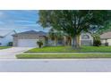 Charming single-story home with a well-manicured lawn and attached two-car garage at 3928 Blackberry Cir, St Cloud, FL 34769