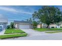 Attractive single-story home with a two-car garage and mature landscaping at 3928 Blackberry Cir, St Cloud, FL 34769