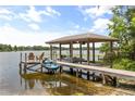 Lakefront dock with boat and jet ski lifts, a seating area, and beautiful water views at 430 Bywater Dr, Orlando, FL 32839