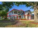 Charming two-story home featuring a brick-accented facade and attached garage, surrounded by lush landscaping at 4700 Buggywhip Ln # 102, Orlando, FL 32812