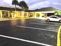 Inviting building with illuminated windows, covered entrance, and a well-lit parking area showcasing a modern facade at 5245 W Irlo Bronson Memorial Hwy # 194, Kissimmee, FL 34746