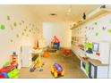 Cheerful playroom featuring vibrant decor, assorted toys, and organized shelving offering an imaginative space for children at 5245 W Irlo Bronson Memorial Hwy # 194, Kissimmee, FL 34746