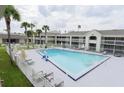 Resort style pool surrounded by palm trees, lounge chairs and multiple levels of condo style balconies at 5245 W Irlo Bronson Memorial Hwy # 194, Kissimmee, FL 34746