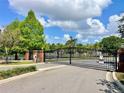 Gated entrance to the community featuring brick columns and landscaping, ensuring privacy and security for residents at 671 Carey Way, Orlando, FL 32825