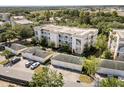 Aerial view of a condominium complex, highlighting the building's layout, surrounding greenery, and individual garages at 7505 Mourning Dove Cir # 201, Reunion, FL 34747