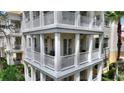 Close up of a three-story condo featuring balconies with classic architectural details at 7509 Mourning Dove Cir # 201, Reunion, FL 34747