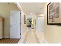Inviting hallway with tiled floor leading to a bright living area, enhanced by tasteful decor at 7509 Mourning Dove Cir # 201, Reunion, FL 34747