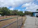 Expansive outdoor space with a driveway leading to a charming blue home at 8704 Tom Costine Rd, Lakeland, FL 33809