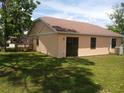 The back of the house has a big yard with a sliding door to the inside at 8750 Se 88Th Ave, Ocala, FL 34472
