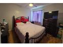Cozy bedroom with a comfortable bed, dresser, and ceiling fan, perfect for relaxation at 101 Grand Junction Blvd, Orlando, FL 32835