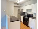Modern kitchen with updated stainless steel appliances and bright white cabinets at 2213 Metropolitan Way # 1318, Orlando, FL 32839