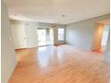 Spacious living room with natural light, laminate floors, and sliding door to outdoor patio at 2213 Metropolitan Way # 1318, Orlando, FL 32839