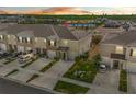 An aerial view shows the townhome's proximity to a tranquil pond, providing a serene backdrop at 2302 Tay Wes Dr, St Cloud, FL 34771