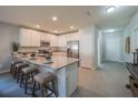 Eat-in kitchen island with granite countertops and pendant lighting, stainless appliances and ample cabinetry at 248 Cheshire Ct, Kissimmee, FL 34758