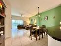 Open-concept living room features a comfortable seating area, tile flooring, and sliding glass doors to the outside at 2788 Sun Key Pl, Kissimmee, FL 34747