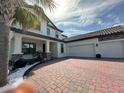 Charming two-story home featuring a brick driveway and a two-car garage at 2920 Agostino Ter, Kissimmee, FL 34746