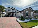 Elegant two-story home featuring a brick driveway, attached two-car garage and beautifully landscaped front yard at 2920 Agostino Ter, Kissimmee, FL 34746
