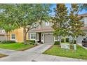 Charming two-story home features a well-manicured lawn, a two-car garage, and mature trees offering ample shade at 2985 Banana Palm Dr, Kissimmee, FL 34747